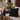 Cuscino nero ricamato stile marocchino ambientato in giardino orientale luxury con lanterne e dettagli boho chic