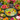 Piatto decorativo Blossom con fantasia tropicale colorata su fondo giallo