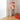 Tappeto decorativo rotondo arancione in ambiente moderno con consolle e vaso coordinato