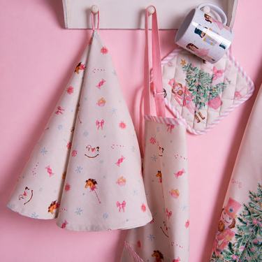 Asciugamano da cucina natalizio beige e rosa con fiocchi di neve e dolcetti
