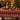 Tovaglia natalizia rossa 140x220 cm con fiocchi di neve e casette decorative